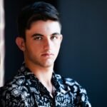 man in black and white floral collared shirt